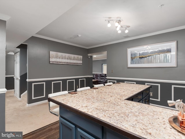 kitchen featuring dark carpet, ornamental molding, and blue cabinets