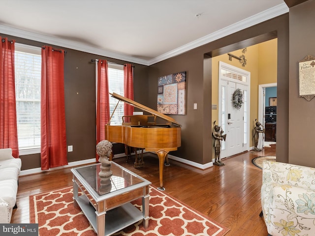 living room with hardwood / wood-style flooring, crown molding, and a healthy amount of sunlight