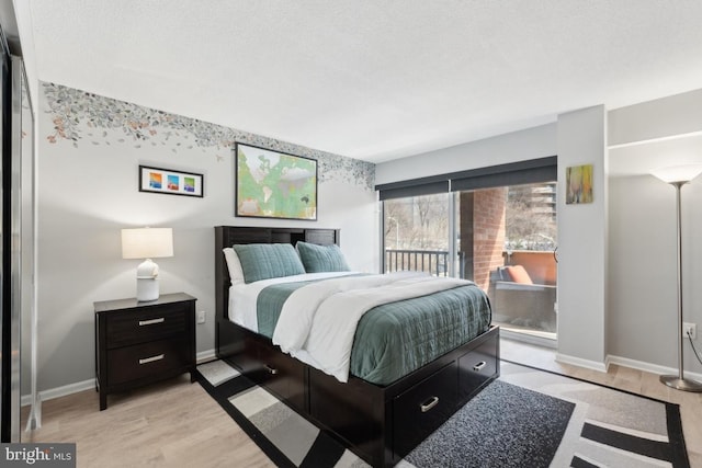 bedroom with a textured ceiling and light hardwood / wood-style flooring