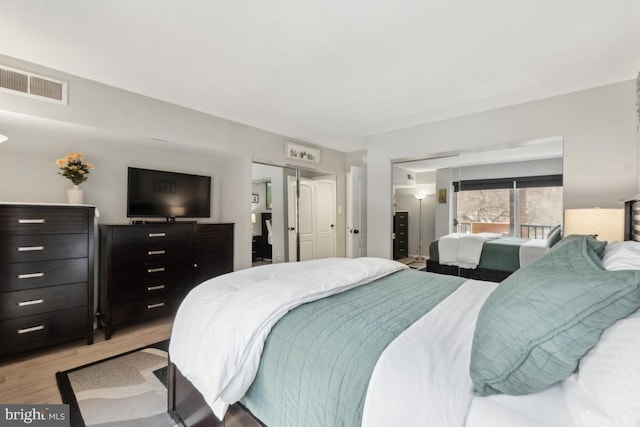 bedroom with light wood-type flooring and a closet