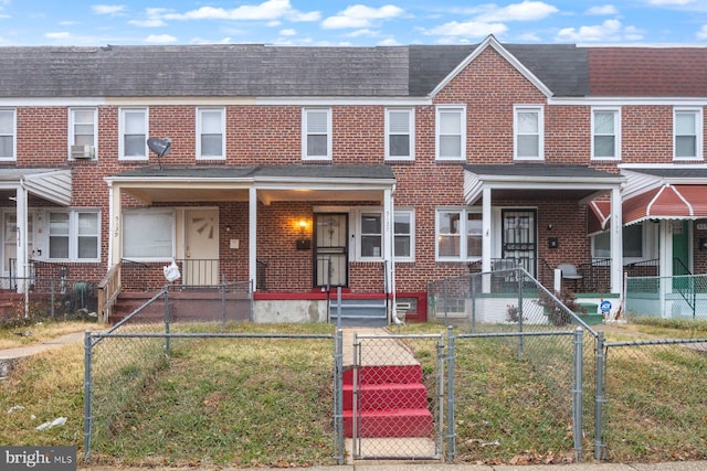 townhome / multi-family property with a porch and cooling unit