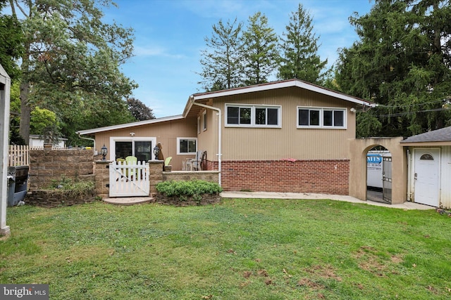 rear view of house featuring a yard