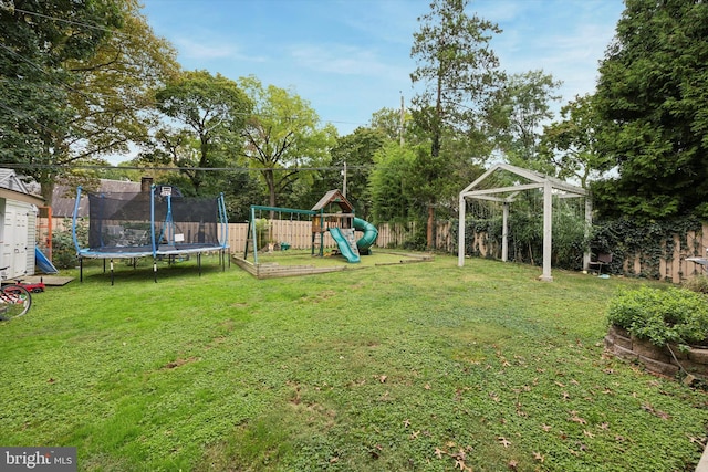 view of yard with a playground and a trampoline