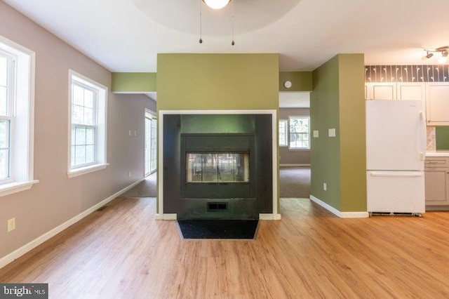 unfurnished living room featuring light wood-type flooring