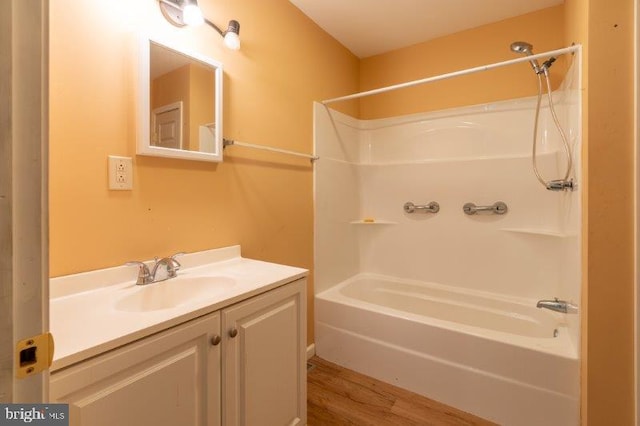 bathroom with vanity, shower / bathtub combination, and hardwood / wood-style flooring