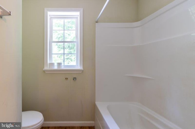 bathroom featuring toilet and shower / tub combination