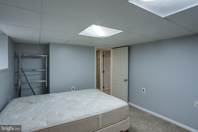 carpeted bedroom featuring a paneled ceiling