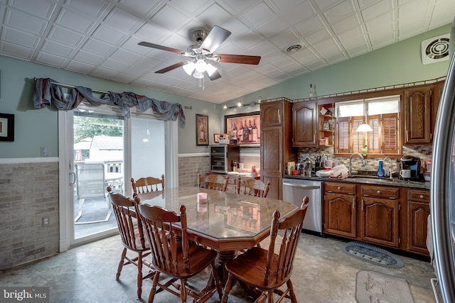 dining room featuring ceiling fan, sink, and lofted ceiling