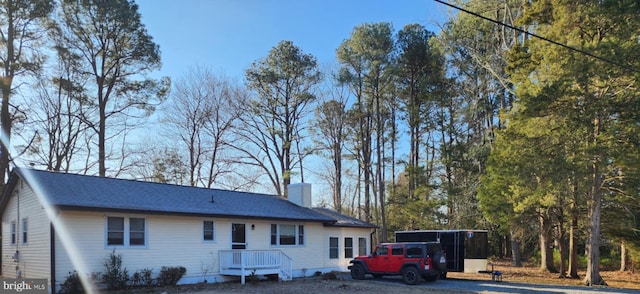 view of front of property with gravel driveway and a chimney