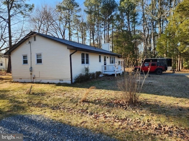 view of property exterior featuring crawl space and a chimney