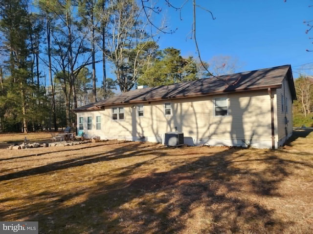 rear view of house featuring central AC