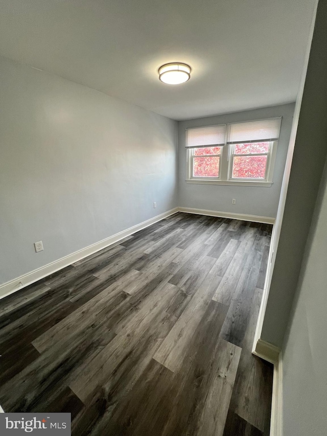 spare room featuring dark hardwood / wood-style flooring