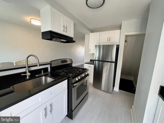 kitchen featuring appliances with stainless steel finishes, white cabinetry, and sink