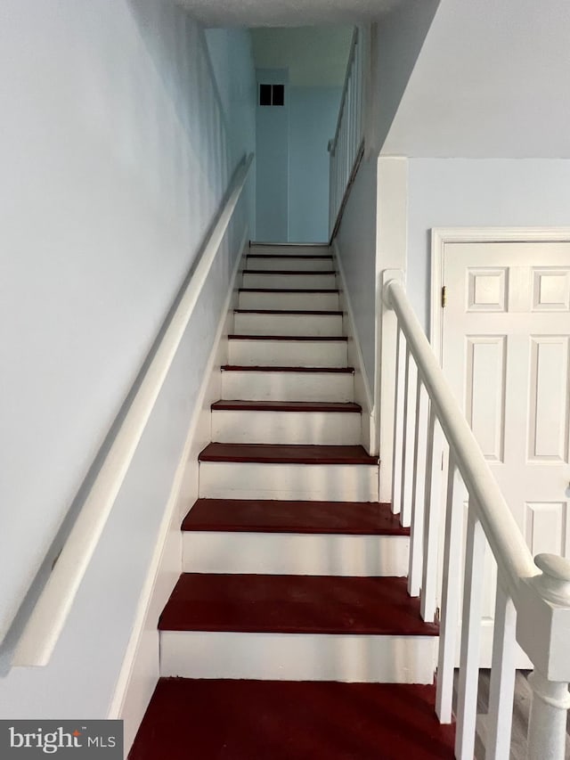 stairway featuring hardwood / wood-style floors