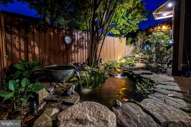 view of yard at twilight