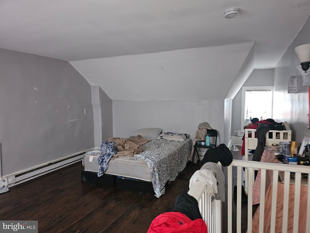 bedroom with hardwood / wood-style floors, vaulted ceiling, and a baseboard heating unit