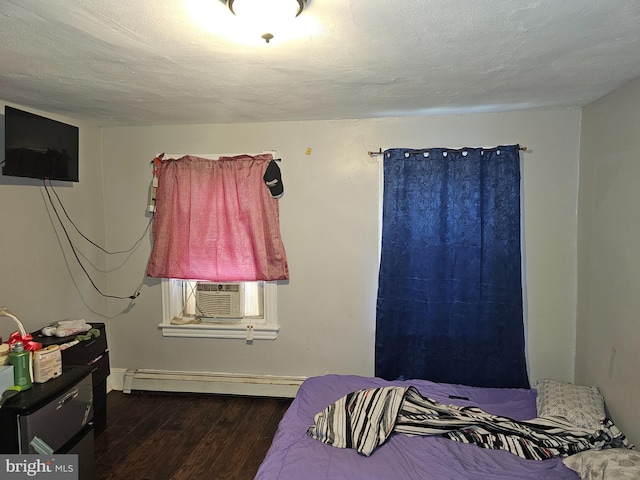 bedroom featuring cooling unit, dark hardwood / wood-style flooring, a textured ceiling, and a baseboard radiator