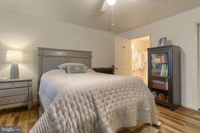 bedroom with ensuite bathroom, ceiling fan, and light wood-type flooring