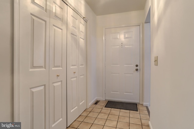 doorway with light tile patterned floors