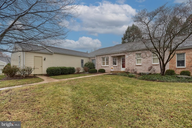 ranch-style home with a front lawn