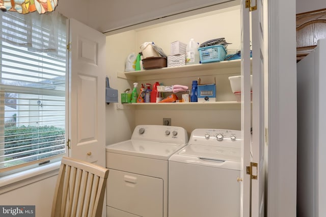 clothes washing area featuring washer and clothes dryer and plenty of natural light