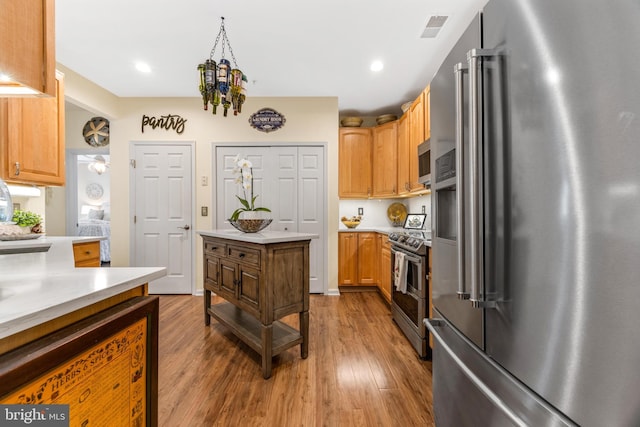 kitchen featuring hardwood / wood-style flooring and stainless steel appliances