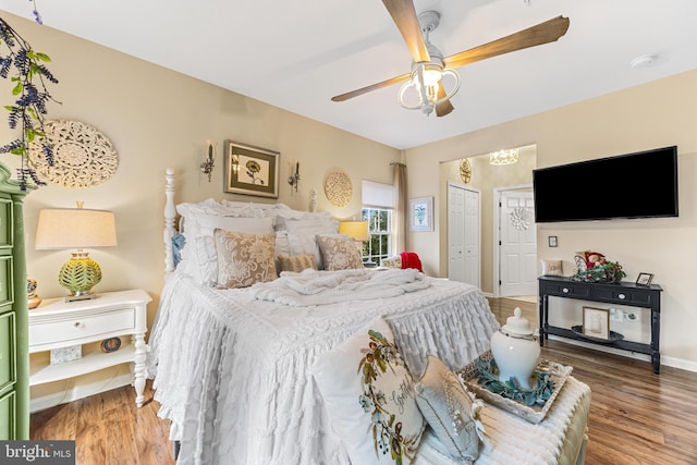 bedroom with hardwood / wood-style floors and ceiling fan