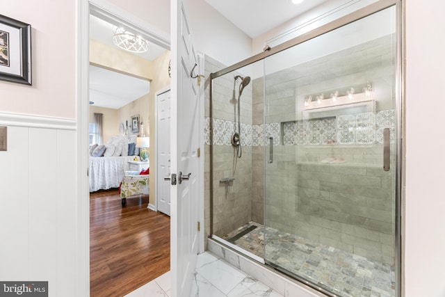 bathroom featuring hardwood / wood-style flooring and a shower with door