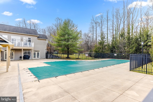 view of pool featuring a patio area and french doors