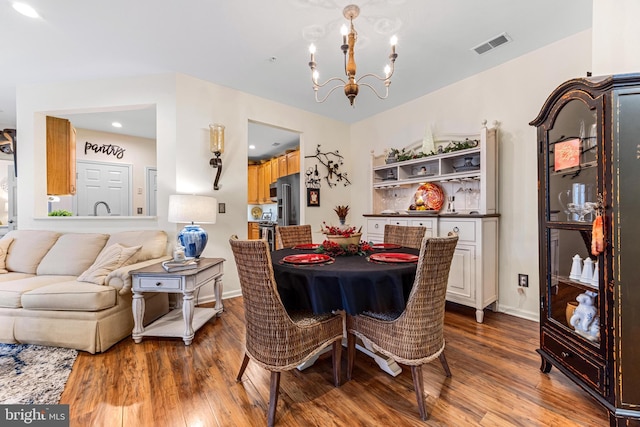 dining room featuring a notable chandelier and hardwood / wood-style flooring