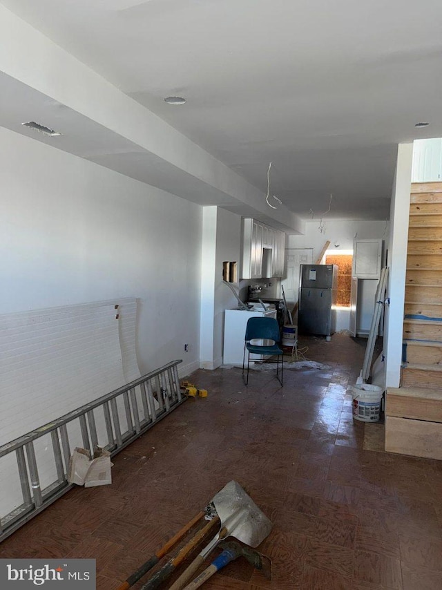 basement with dark hardwood / wood-style flooring