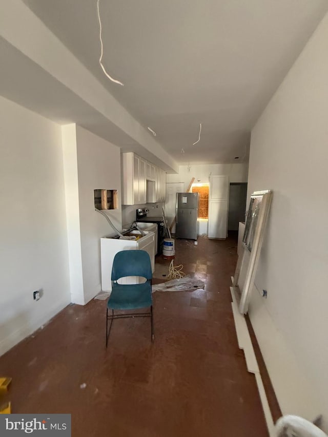 interior space featuring washer / clothes dryer and stainless steel refrigerator