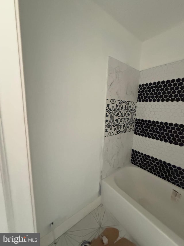 bathroom with a bathing tub and tile patterned floors