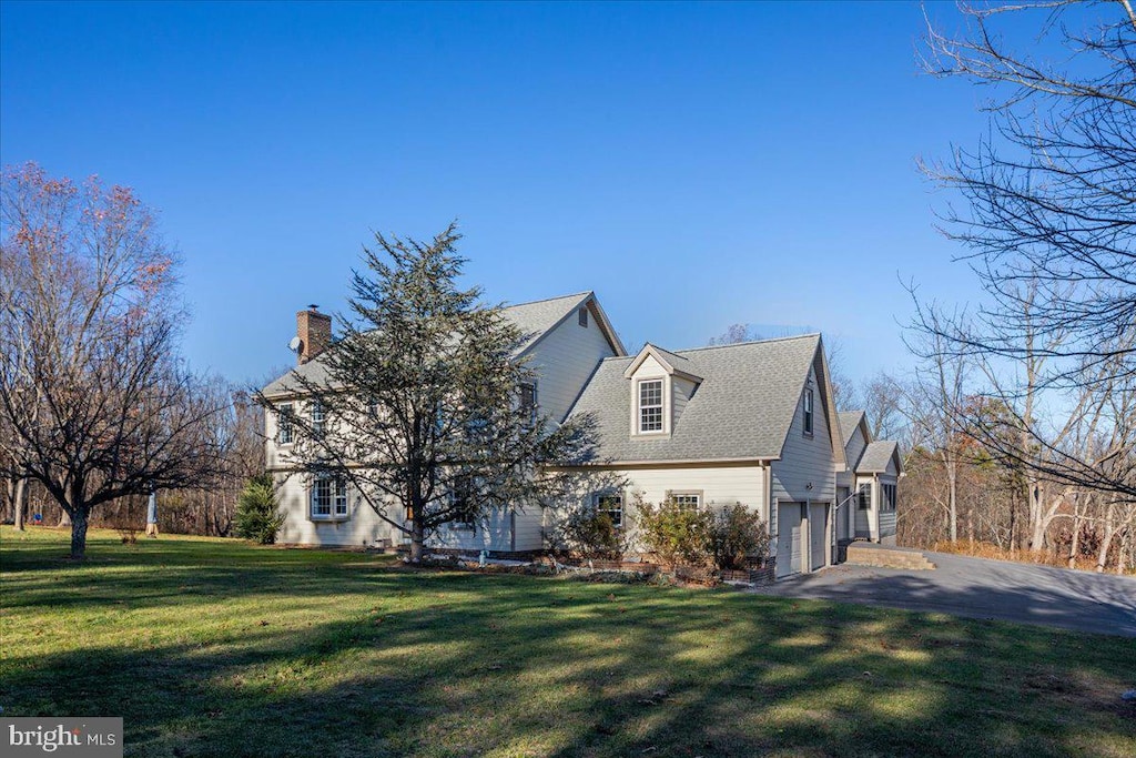 view of side of home featuring a yard and a garage