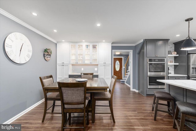 dining area featuring dark hardwood / wood-style floors and ornamental molding