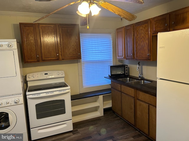 kitchen with white appliances, crown molding, sink, dark hardwood / wood-style floors, and stacked washer / dryer