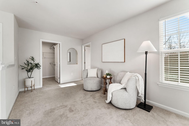 living area with a wealth of natural light and light carpet