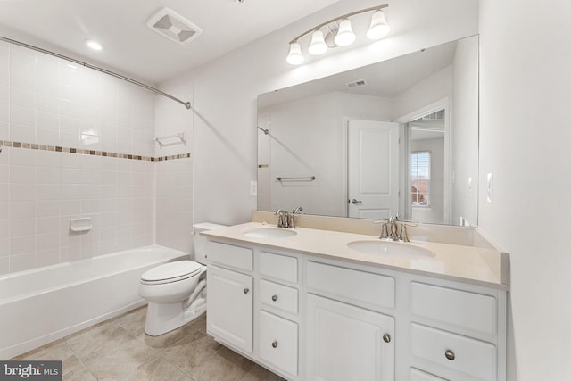 full bathroom featuring vanity, toilet, and tiled shower / bath combo