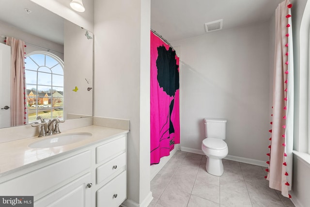 bathroom featuring tile patterned flooring, vanity, and toilet