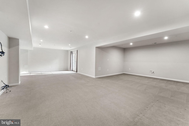 basement featuring light colored carpet