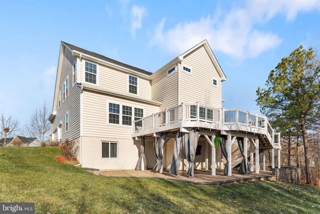 back of property featuring a yard, a patio, and a wooden deck