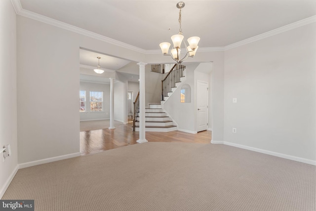 interior space with decorative columns, an inviting chandelier, and crown molding