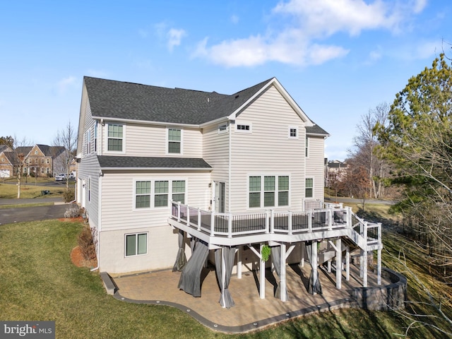 back of house with a deck, a yard, and a patio