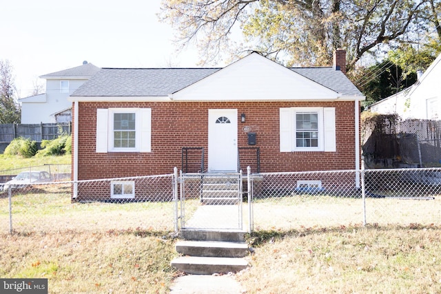 bungalow-style home with a front yard