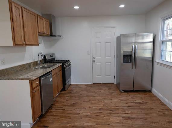 kitchen with sink, dark hardwood / wood-style flooring, and appliances with stainless steel finishes