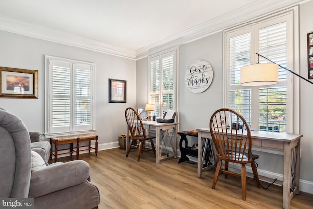 office with light wood-type flooring and ornamental molding