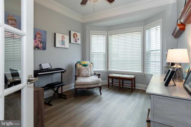 living area featuring hardwood / wood-style flooring, ceiling fan, and ornamental molding