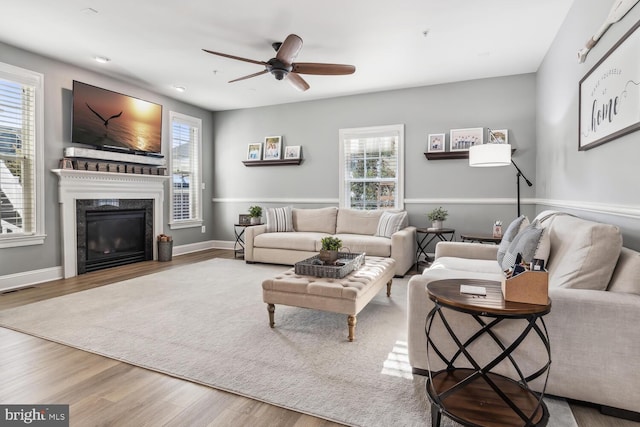 living room with hardwood / wood-style floors, ceiling fan, and a healthy amount of sunlight