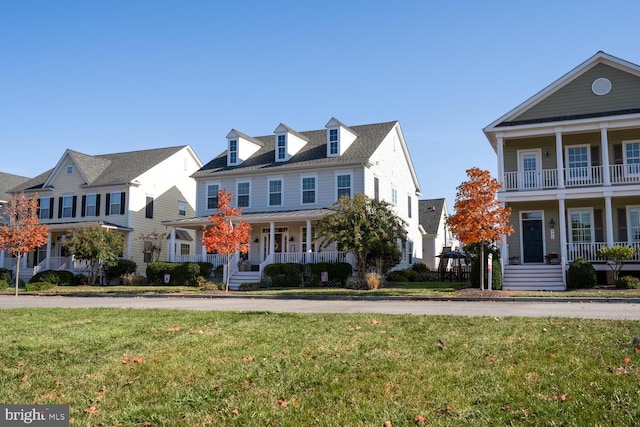 view of front of property with covered porch and a front lawn