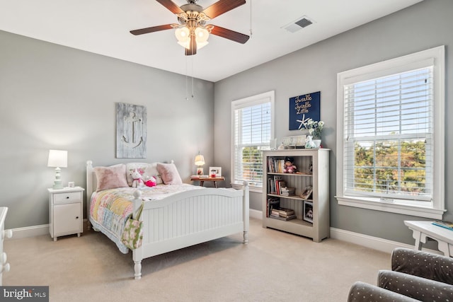 carpeted bedroom with multiple windows and ceiling fan